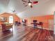 Large bonus room with hardwood floors and multiple ceiling fans provides the perfect space to relax at 914 Olive Mill Ln, Matthews, NC 28104