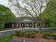 Exterior shot of the building with a paved driveway, landscaping and columns at 914 Olive Mill Ln, Matthews, NC 28104