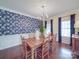 Elegant dining room with hardwood floors, bright windows, and decorative wallpaper at 914 Olive Mill Ln, Matthews, NC 28104