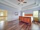 Bright main bedroom features hardwood floors, crown molding, and a connecting door to the hallway at 914 Olive Mill Ln, Matthews, NC 28104