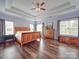 Spacious main bedroom features a tray ceiling, hardwood floors, and many windows offering natural light at 914 Olive Mill Ln, Matthews, NC 28104