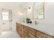 Bathroom boasts double sinks, white countertops and brass fixtures at 933 Tennyson Dr, Charlotte, NC 28208