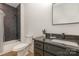 Chic bathroom with walk-in shower featuring black tile and neutral colored walls at 933 Tennyson Dr, Charlotte, NC 28208