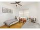 Bright bedroom with two twin beds, a ceiling fan and neutral colored walls at 933 Tennyson Dr, Charlotte, NC 28208
