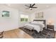 This primary bedroom features a neutral color palette, natural light and a geometrically patterned rug at 933 Tennyson Dr, Charlotte, NC 28208