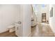 Bright foyer with high ceilings, an open staircase, light wood floors, and a convenient half-bathroom at 933 Tennyson Dr, Charlotte, NC 28208