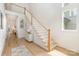 Bright entryway featuring an open staircase, light wood floors, and modern decor for a welcoming feel at 933 Tennyson Dr, Charlotte, NC 28208