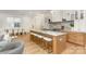Modern kitchen with a large island, marble countertops, and stainless steel appliances open to the living area at 933 Tennyson Dr, Charlotte, NC 28208