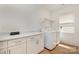 Laundry room features white cabinetry, countertops and washer/dryer at 933 Tennyson Dr, Charlotte, NC 28208