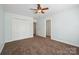 Bedroom featuring a ceiling fan, carpet, and closet at 10101 Bayart Way, Huntersville, NC 28078