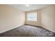 Bright bedroom with neutral walls, plush carpet, and a window allowing ample natural light at 10101 Bayart Way, Huntersville, NC 28078