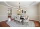 Elegant dining room with a chandelier, table with seating for six, and views into the kitchen at 10101 Bayart Way, Huntersville, NC 28078