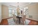 Elegant dining room with large windows, shutters, tray ceiling, and stylish chandelier at 10101 Bayart Way, Huntersville, NC 28078