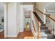 Spacious foyer featuring wood floors, staircase with white railings, and a view into the dining room at 10101 Bayart Way, Huntersville, NC 28078