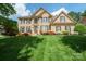 Beautiful two-story brick home with a well-manicured lawn, mature landscaping, and a welcoming front entrance at 10101 Bayart Way, Huntersville, NC 28078