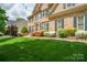 Charming brick home featuring a manicured lawn, colorful landscaping, and a welcoming entrance with iron railings at 10101 Bayart Way, Huntersville, NC 28078