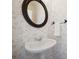 Charming half bathroom featuring an oval mirror, patterned wallpaper, and a pedestal sink at 10101 Bayart Way, Huntersville, NC 28078