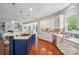 Open kitchen featuring a gas cooktop, stainless steel appliances, hardwood floors, and backyard views at 10101 Bayart Way, Huntersville, NC 28078