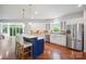 Spacious kitchen boasts a marble island, stainless steel appliances, hardwood floors, and backyard access at 10101 Bayart Way, Huntersville, NC 28078
