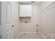 Laundry room with tile flooring, cabinets, and hookups for washer and dryer at 10101 Bayart Way, Huntersville, NC 28078