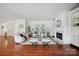 Spacious living room with hardwood floors, fireplace, built-in shelving, and an open floor plan at 10101 Bayart Way, Huntersville, NC 28078