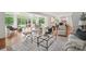 Open concept living area with hardwood floors, bathed in natural light from large windows overlooking the backyard at 10101 Bayart Way, Huntersville, NC 28078
