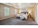 Serene main bedroom boasts tray ceilings, plantation shutters, and stylish decor at 10101 Bayart Way, Huntersville, NC 28078
