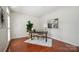 Bright home office with hardwood floors, a stylish desk, and ample natural light, perfect for remote work at 10101 Bayart Way, Huntersville, NC 28078