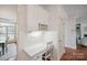 Bright office nook with built-in desk, white cabinetry, and wood paneled walls at 10101 Bayart Way, Huntersville, NC 28078