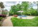 Backyard featuring a sparkling pool with surrounding landscaping, perfect for enjoying sunny days and outdoor gatherings at 10101 Bayart Way, Huntersville, NC 28078