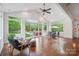 Inviting sunroom with vaulted ceilings and floor-to-ceiling windows offering views of the pool and backyard at 10101 Bayart Way, Huntersville, NC 28078