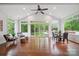 Bright sunroom with hardwood floors, featuring views of the landscaped backyard and a sparkling pool at 10101 Bayart Way, Huntersville, NC 28078