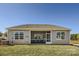 Rear view of a home with a screened porch and well-manicured lawn at 103 White Apple Way, Statesville, NC 28625