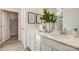 Bathroom with double sinks, white cabinetry, framed mirror, and walk-in closet at 103 White Apple Way, Statesville, NC 28625