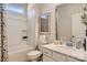 Well-lit bathroom features a shower-tub combo, white vanity, and framed art at 103 White Apple Way, Statesville, NC 28625