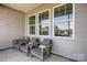 Comfortable covered porch with three armchairs and view of backyard at 103 White Apple Way, Statesville, NC 28625