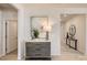 Well-lit hallway featuring a decorative chest with drawers, stylish decor, and access to multiple rooms at 103 White Apple Way, Statesville, NC 28625