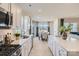 Contemporary kitchen featuring stainless steel appliances, white cabinetry, and a large island open to the dining area at 103 White Apple Way, Statesville, NC 28625