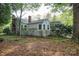 View of backyard showcasing fencing, brick chimney, and mature landscaping that enhance privacy and visual appeal at 1059 16Th Nw Ave, Hickory, NC 28601