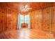 Inviting bedroom with knotty pine walls, hardwood floors, and corner windows at 1059 16Th Nw Ave, Hickory, NC 28601
