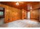 Inviting bedroom featuring hardwood and carpeted floors, ceiling fan, and wood-paneled walls at 1059 16Th Nw Ave, Hickory, NC 28601