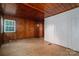 Comfortable bedroom featuring wood-paneled walls, tile floor, and built-in closet space for storage at 1059 16Th Nw Ave, Hickory, NC 28601
