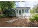 Charming home exterior featuring a cozy sunroom and well-manicured landscaping at 1059 16Th Nw Ave, Hickory, NC 28601