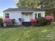 Charming single-story home with a manicured lawn and vibrant azalea bushes lining the front at 1059 16Th Nw Ave, Hickory, NC 28601
