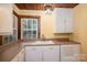 Well-lit kitchen featuring ample counter space, classic cabinetry, and a bright window at 1059 16Th Nw Ave, Hickory, NC 28601