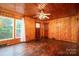 Cozy living room with wood paneling, large windows, and hardwood floors, creating a warm atmosphere at 1059 16Th Nw Ave, Hickory, NC 28601