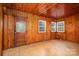 Inviting sunroom with wood paneling, tiled floor, and multiple windows, ideal for relaxation at 1059 16Th Nw Ave, Hickory, NC 28601
