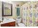 Bathroom featuring a vanity, toilet, and shower with a floral patterned curtain at 10716 Persimmon Creek Dr, Mint Hill, NC 28227