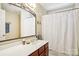 This bathroom features a vanity with a sink, a mirror, and a shower with a curtain at 10716 Persimmon Creek Dr, Mint Hill, NC 28227