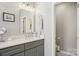 Bathroom with double vanity, mirror, and neutral accents and plentiful lighting at 10716 Persimmon Creek Dr, Mint Hill, NC 28227